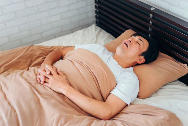 いびきをかいて寝ている男性